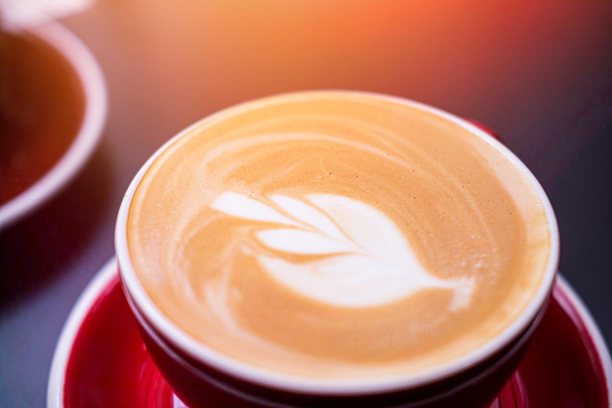 A cup of coffee with coffee art