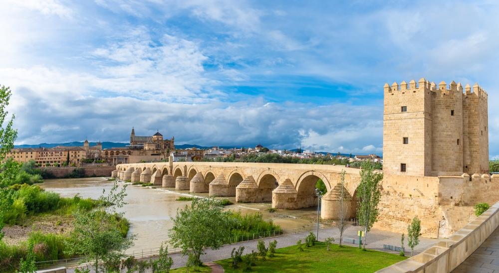 Stroll Across the Historic Roman Bridge at Sunset
