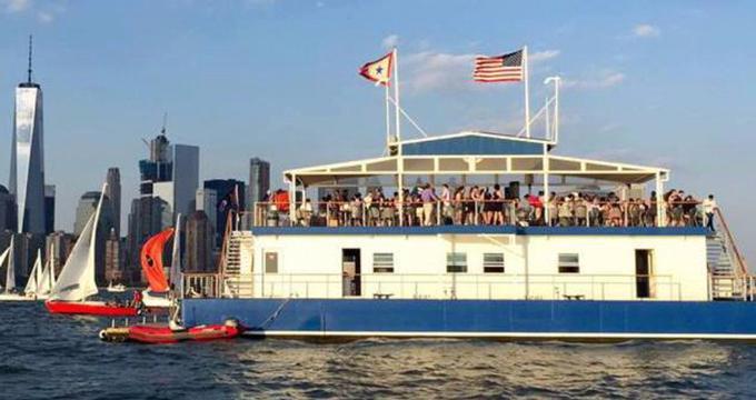 See stunning waterfront views from this floating clubhouse in New York Harbor.