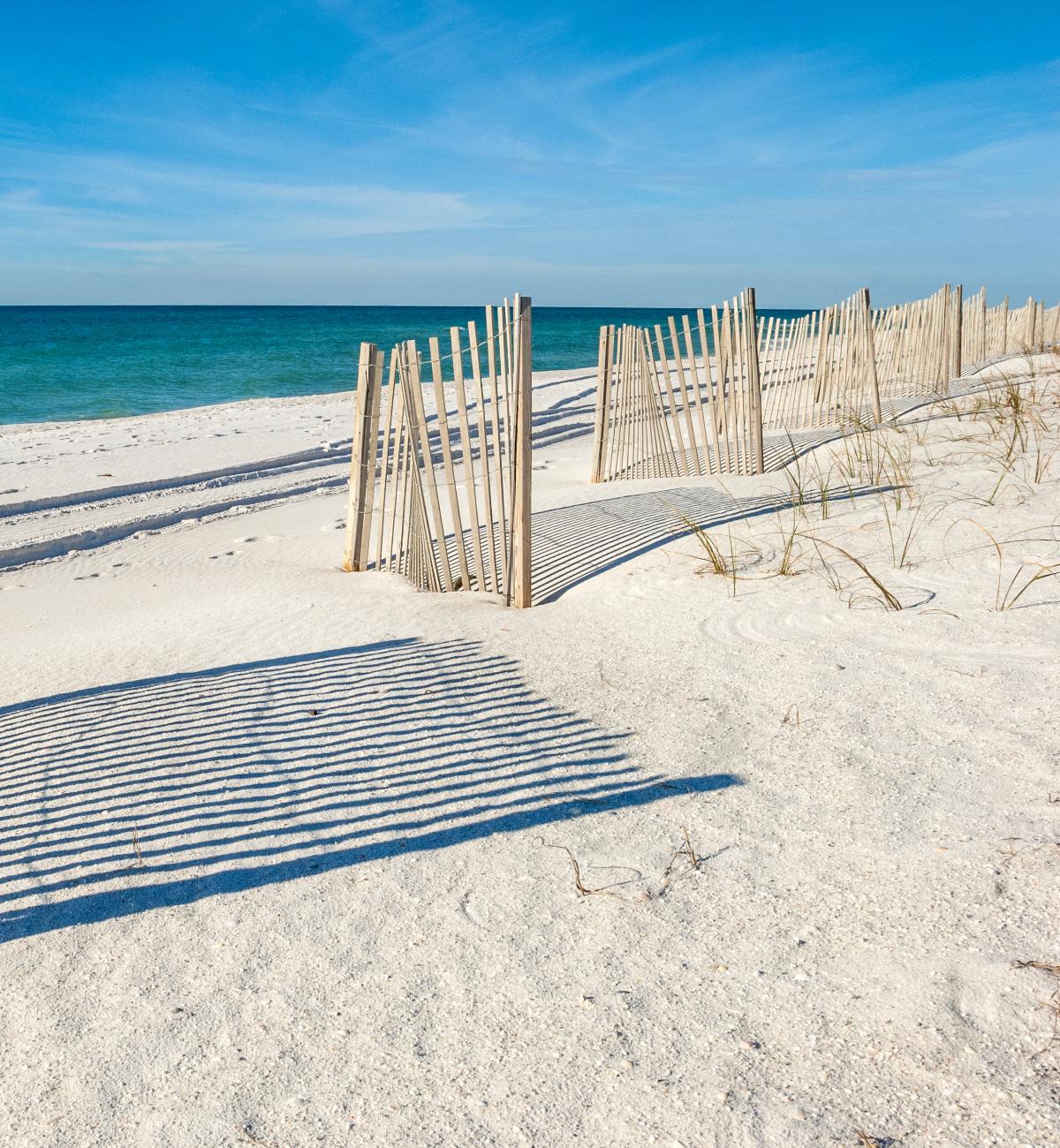 White sandy beach in Alabama. I love how the fences soften the view.