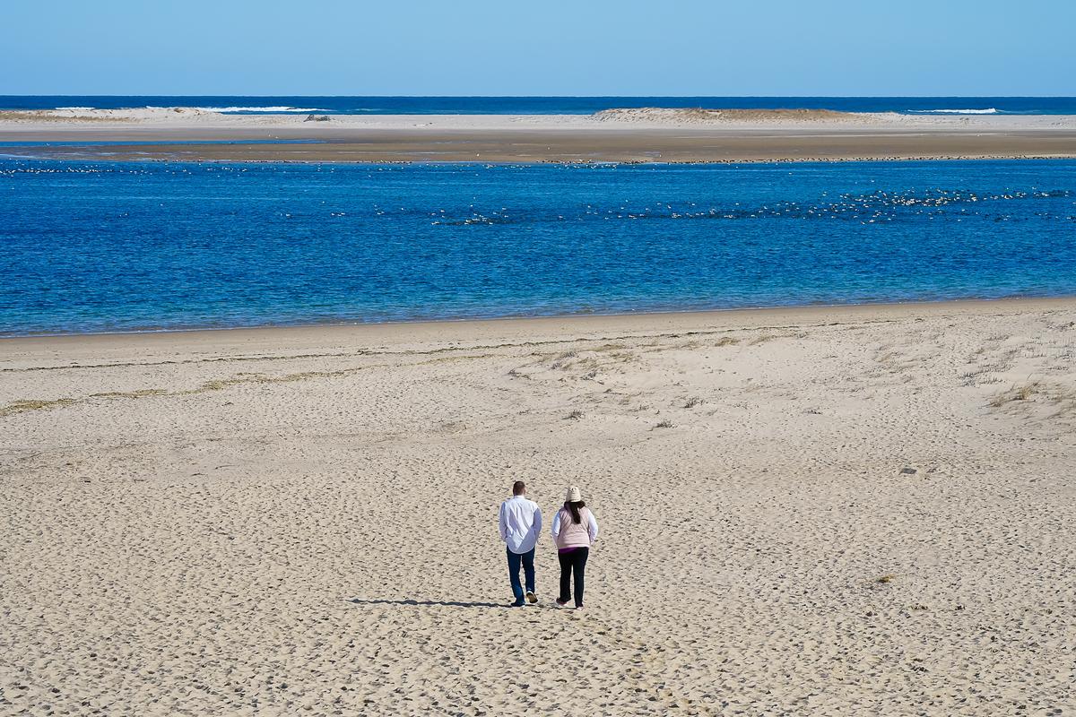 Romantic walk on the beach on a weekend trip.