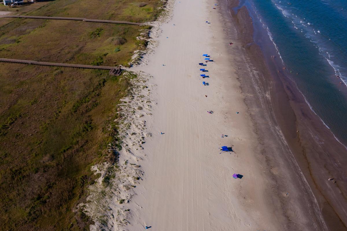 Walking along the dunes and watching surfers
