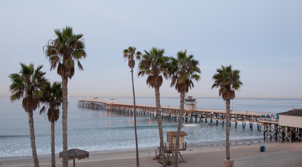 Walk along the pier and browse surf shops with couples.