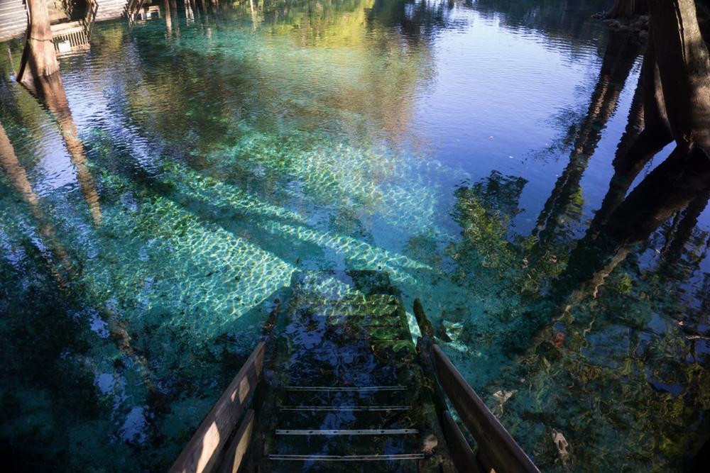 https://stock.adobe.com/gr_en/images/wooden-staircase-steps-going-down-to-the-crystal-clear-turquoise-water-of-ginnie-springs-florida-in-santa-fe-river/225711048