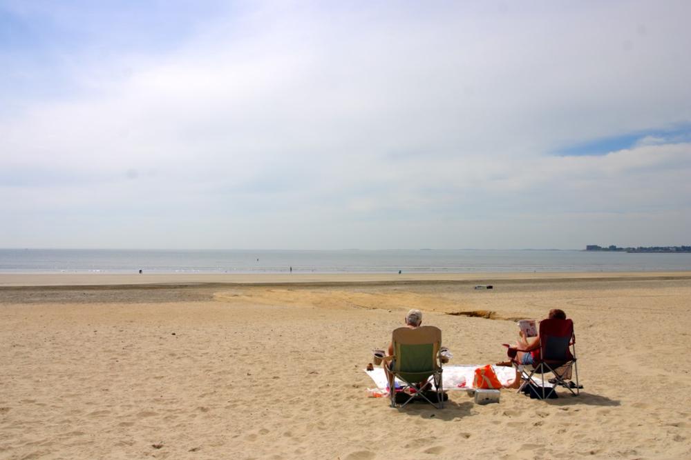 Walk the boardwalk and grab fried clams during a fun summer beach day.