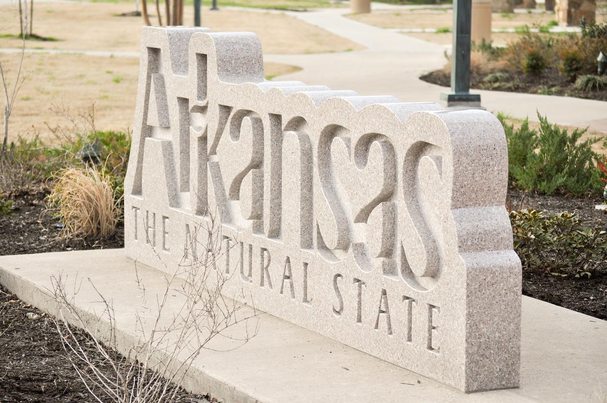 Stone sign that reads Arkansas, the Natural State
