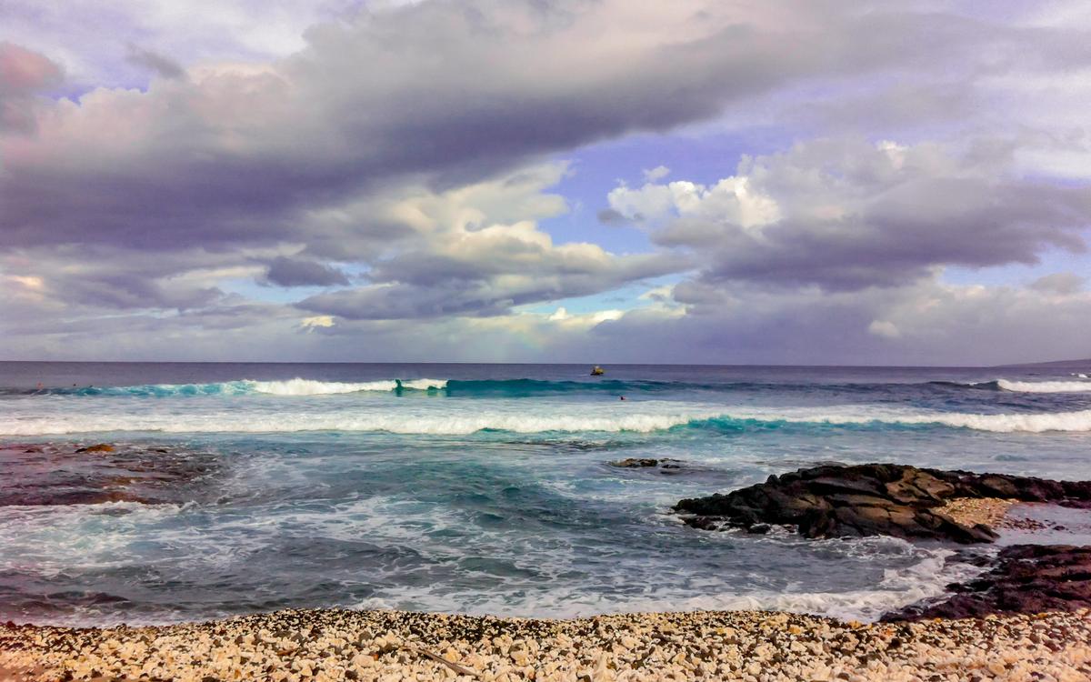 Dramatic sky and ocean with waves rolling towards me as I took the photo near Kona, Hawaii