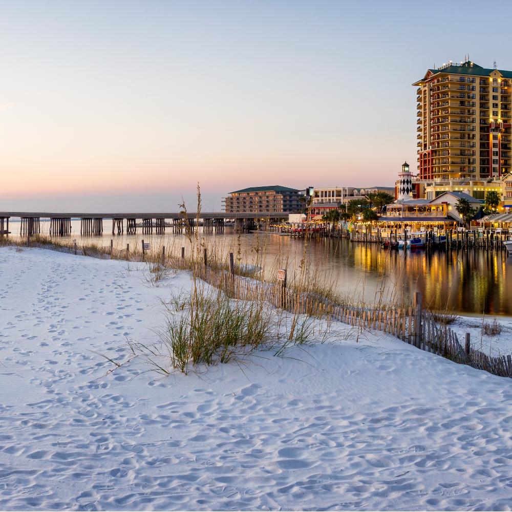 Sandy beach in front of HarborWalk Village in Destin