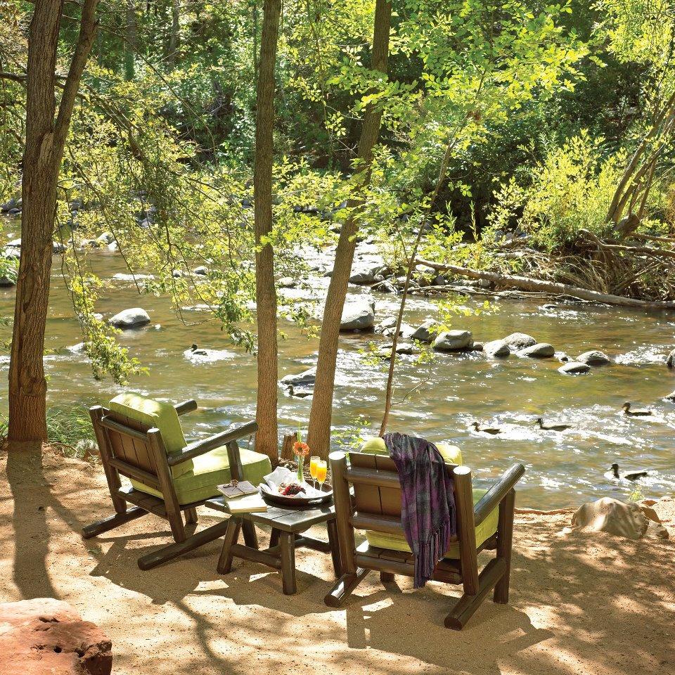 Relax in luxury and look at serene creekside scenery.