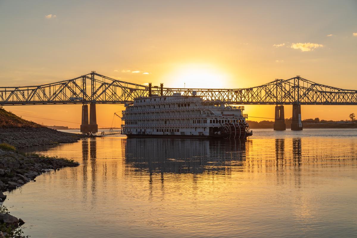 A Paddle Wheeler Ship at Sunset in Front of the John R Junkin Drive Bridge over the Mississippi River