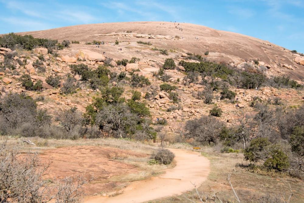 Hike up a massive pink granite dome, admire stunning views, and explore rugged trails.