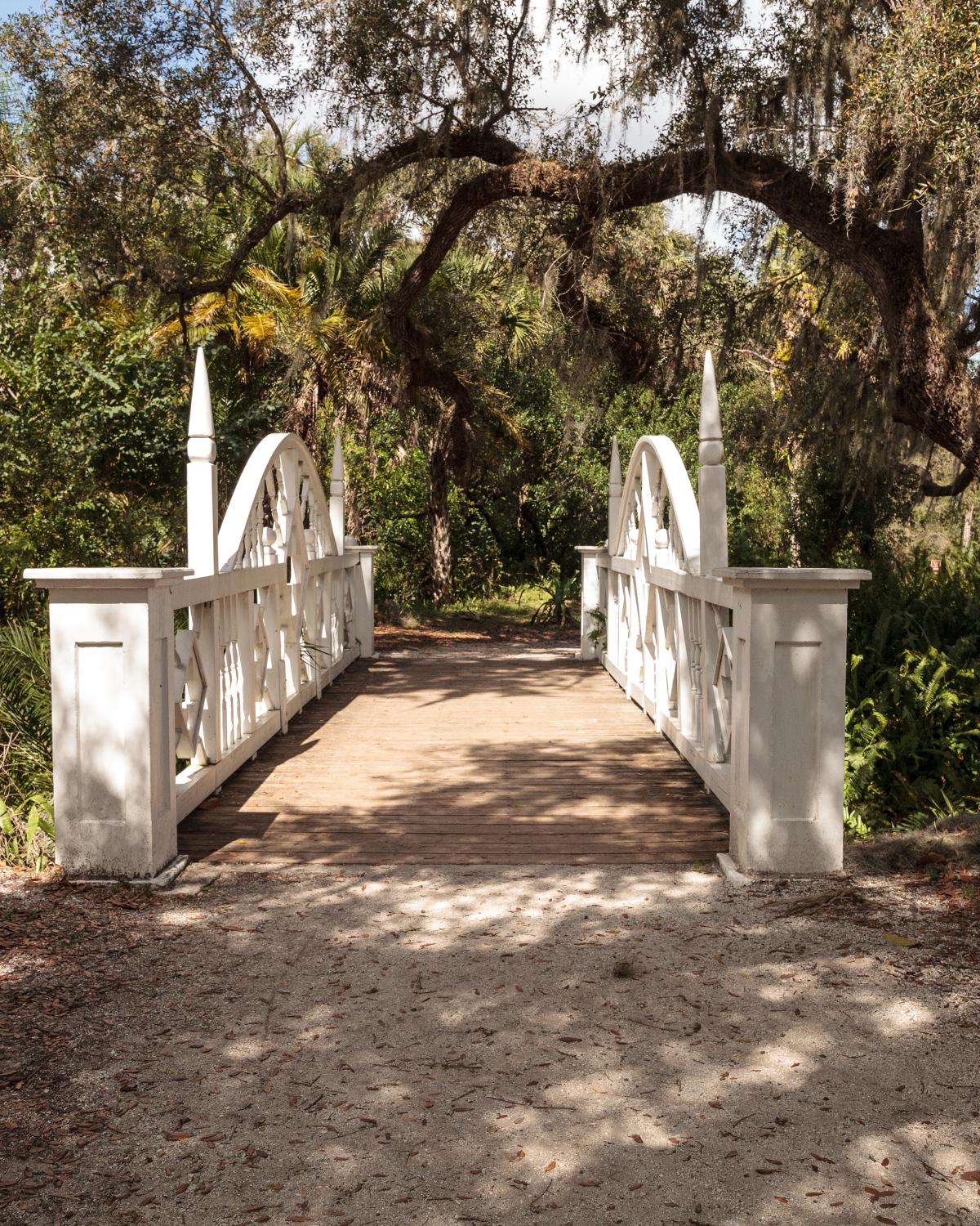 Old wooden bridge along the riverway at historic Koreshan State Park in Estero