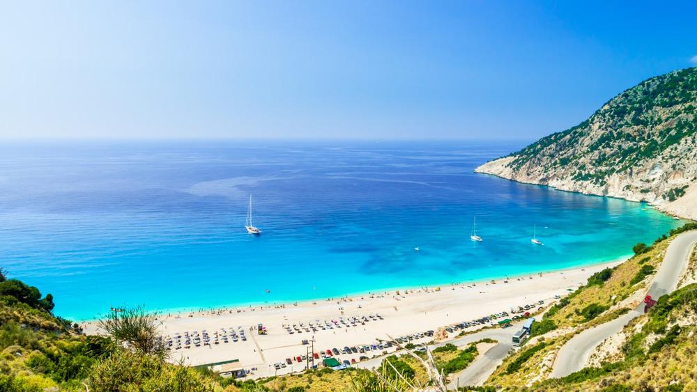 Relax on Myrtos Beach’s white pebbles and admire turquoise waters.