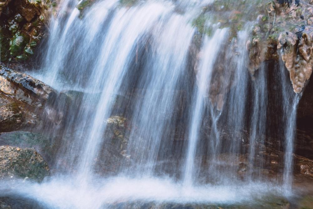 Discover a picturesque waterfall plunging into a deep, rocky gorge.