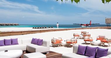 White chairs next to the water