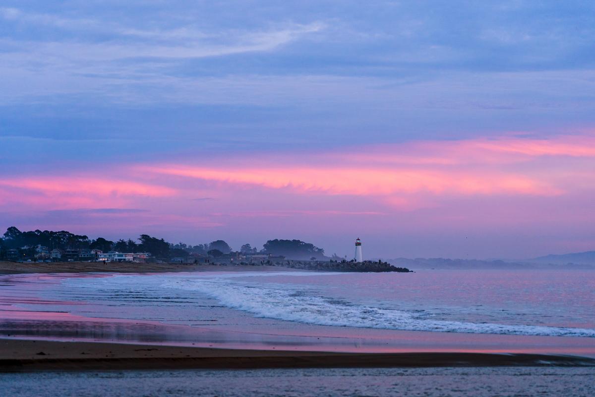 Watch the lighthouse glow and play with kids in gentle surf.