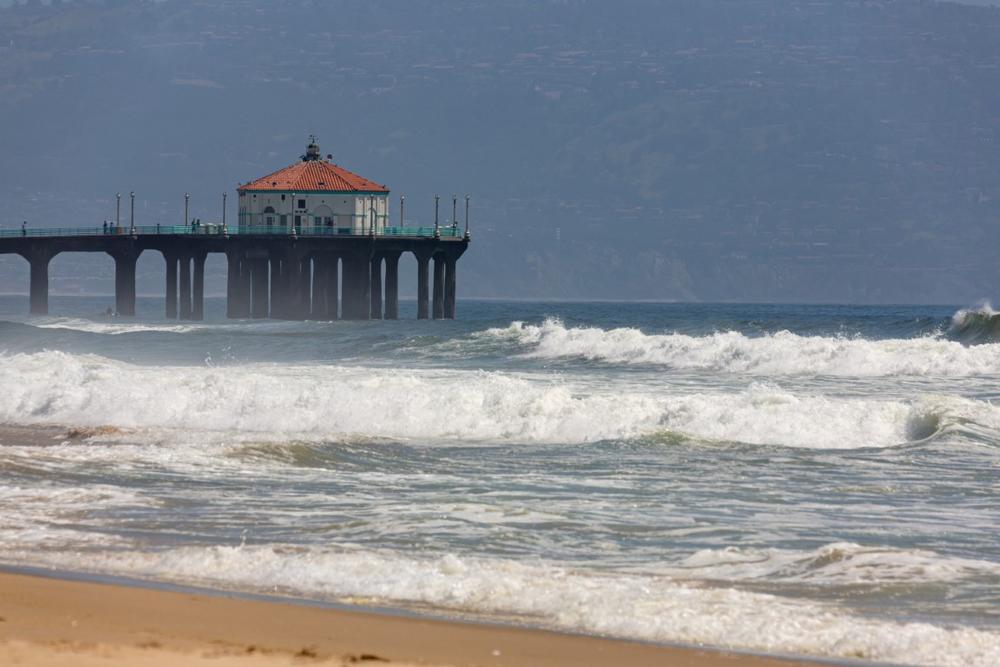 Walk the scenic pier and catch waves during a summer surf session.