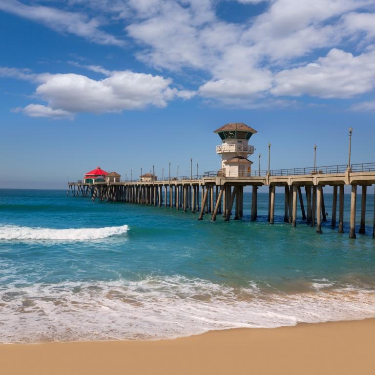 Surf rolling waves and play beach games with kids on a summer afternoon.