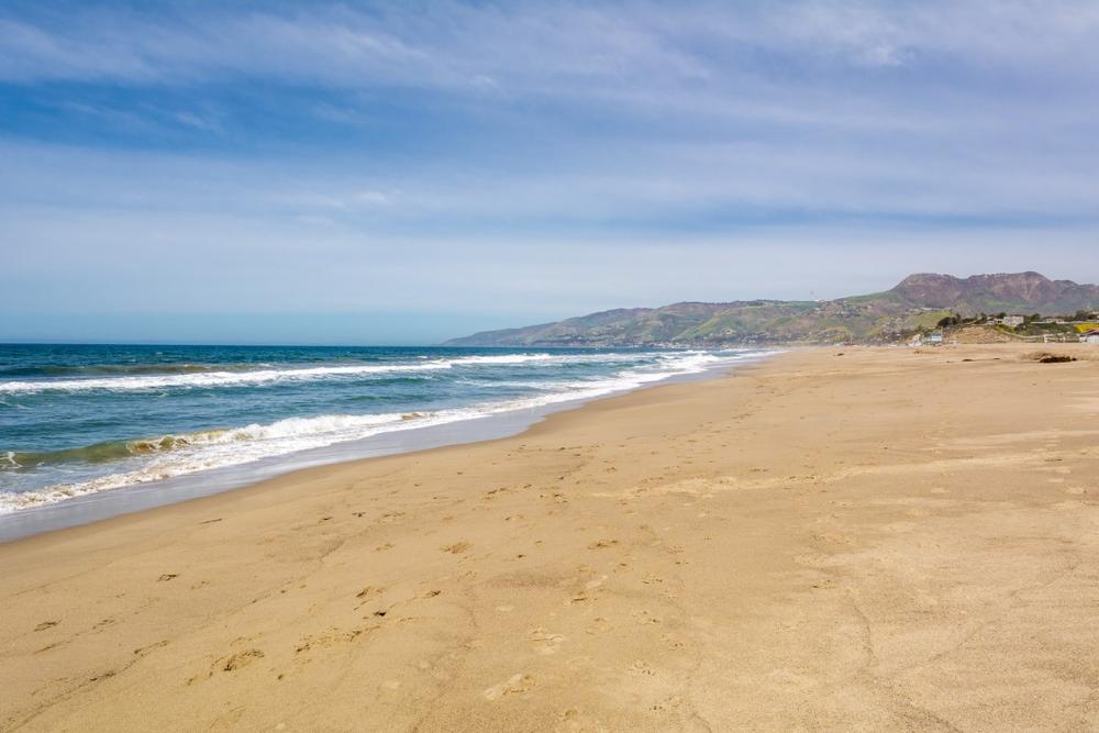 Play volleyball on wide sands and swim with kids in summer waves.