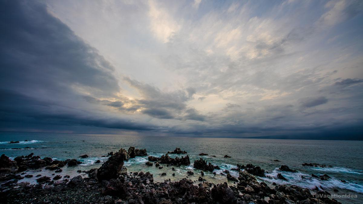 My photo of rocky lava shores in Kona with dramatic clouds