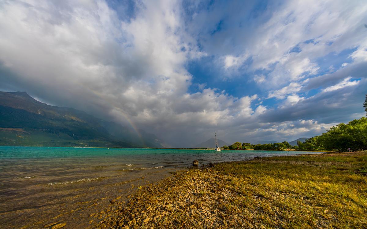 My husband took this photo with a rainbow over the lake in Glenorchy