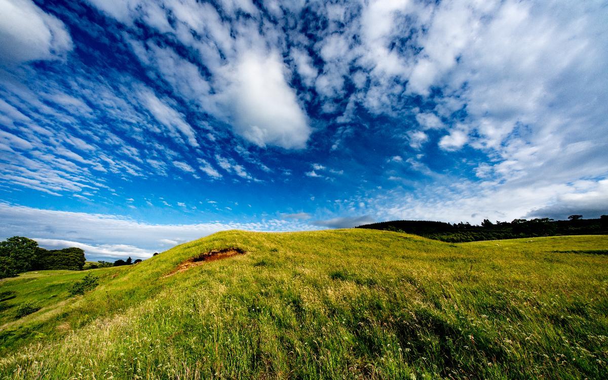 I took this photo of rolling hills and dramatic clouds in Scotland