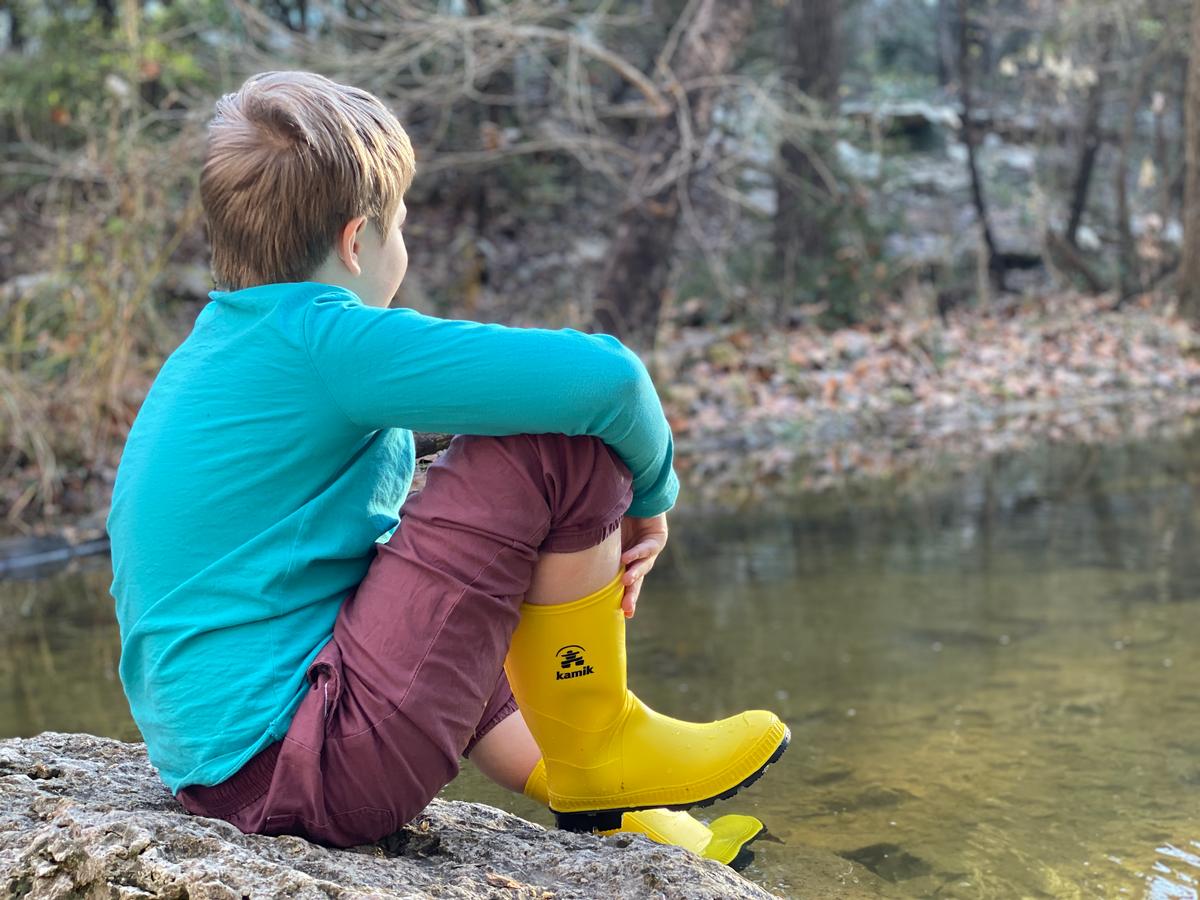My photo of a relaxing day next to a stream with my son on a family trip