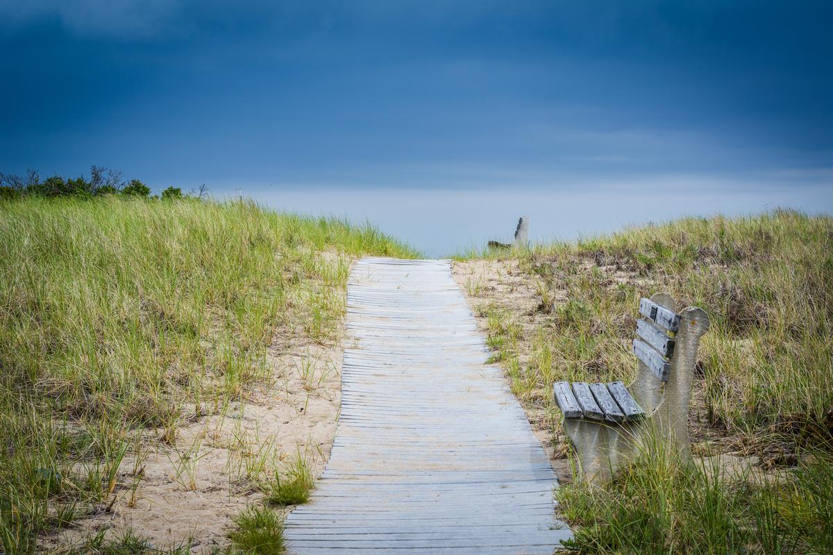 Benches along a walkway over sand dunes to the beach in Seabrook